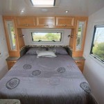 An island queen bed is set into the front area in the Family Tourer