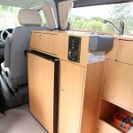 Fridge and sink console behind driver's seat.