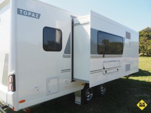 Other external features include a full-length awning, an outside shower and entertainment hatch, which has a table, small TV, speakers, USB, 12v and 240v outlets.